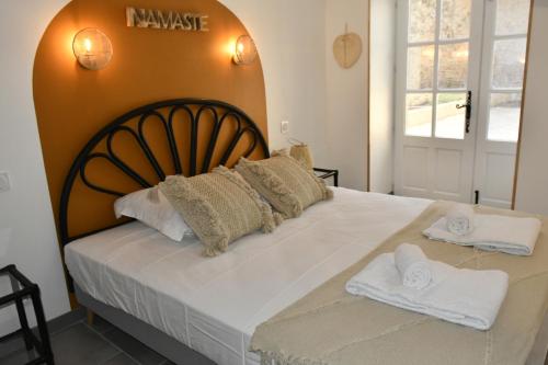 a bedroom with a large bed with white sheets and pillows at Wistéria - Piscine - Le Pré Pommier - BY PRIMO C0NCIERGERIE in Azé