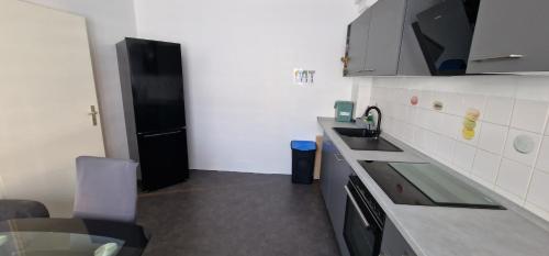 a small kitchen with a sink and a refrigerator at Büdingen Hanau Frankfurt Monteurwohnung in Büdingen
