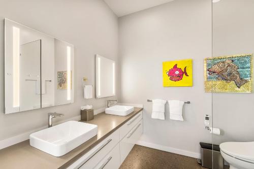 a white bathroom with a sink and a toilet at Hapuna Modern House at Mauna Kea in Hapuna Beach