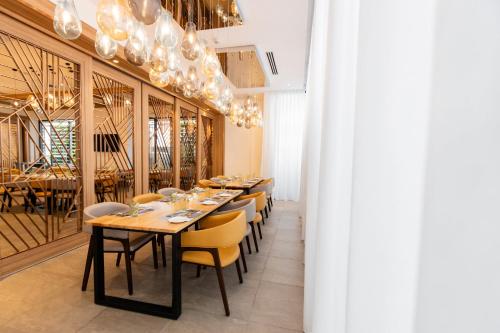 a dining room with a long table and chairs at Holiday Inn Sepang - Airport in Sepang