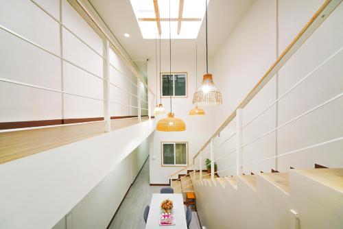 a hallway of a building with a table and chairs at Nut Home Hostel in Ban Ko