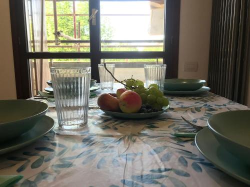 uma mesa com um prato de fruta sobre uma mesa em Trilocale in residence Verdesirente em Rocca di Mezzo