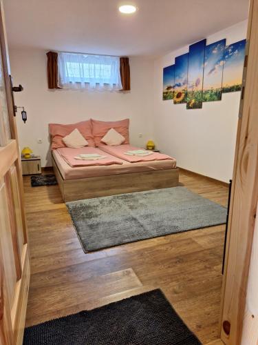 a small bedroom with a bed in a room at Zalán Vendégház in Császártöltés