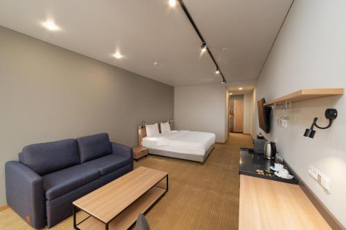 a living room with a couch and a bed at Ambassador Hotel in Bishkek