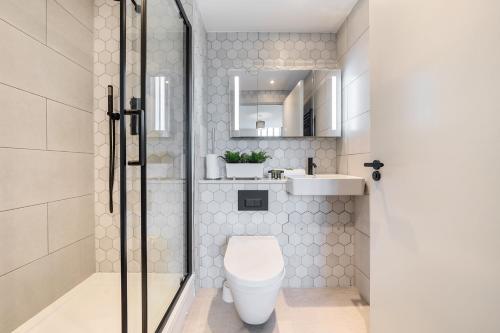 a bathroom with a toilet and a sink at Roomspace Serviced Apartments- Buttermere House in Kingston upon Thames