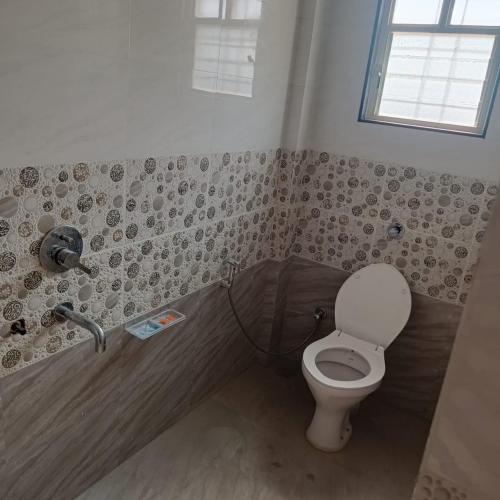 a bathroom with a toilet and a sink at Swapnashilp Bungalow in Hinjewadi