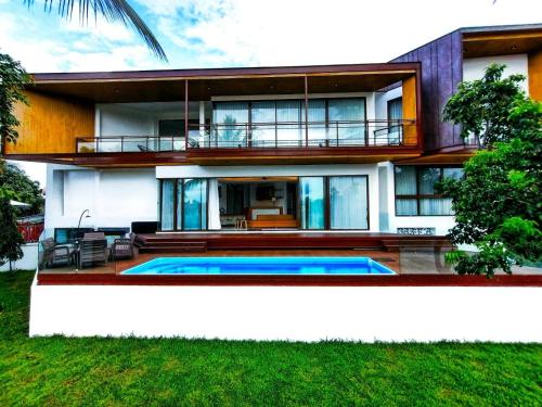 a house with a swimming pool in front of it at Pool Villa Nam Nan in Nan