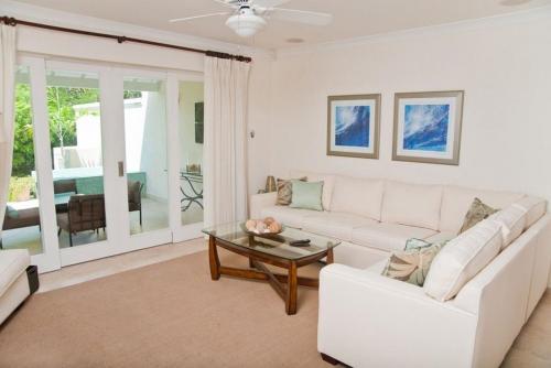 a living room with a white couch and a table at Ocean View Townhouse with Plunge Pool - Palisades 6A townhouse in Christ Church