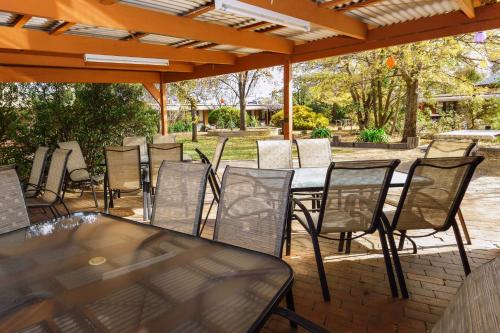 a group of tables and chairs under an umbrella at River Country Inn in Moama