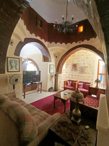a living room with a couch and a table at palm shadow resort in Tunis