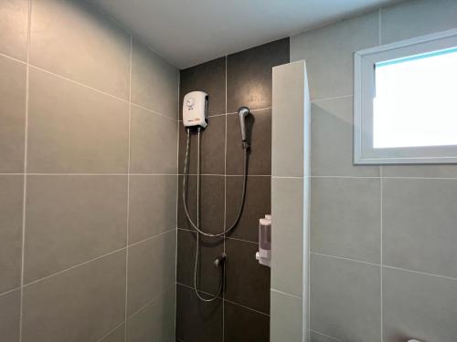 a shower in a bathroom with a shower head at MOST Family 40 Ubon in Ubon Ratchathani