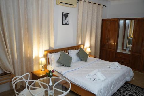 a bedroom with a bed and a table and chairs at Kindo Kicha Farmhouse in Moshi
