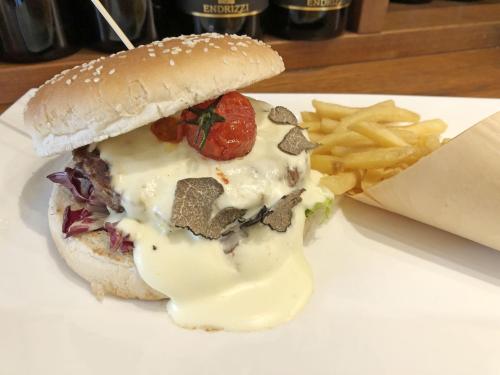 a sandwich and french fries on a white plate at Hotel Lovere Resort & Spa in Lovere