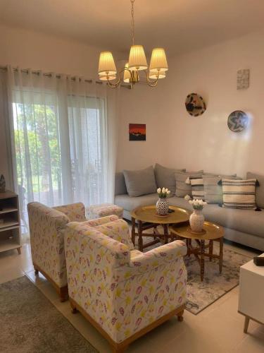a living room with a couch and a table at La Vida Villa Alcudia Smir Fnideq, Holiday Homes in Tetouan
