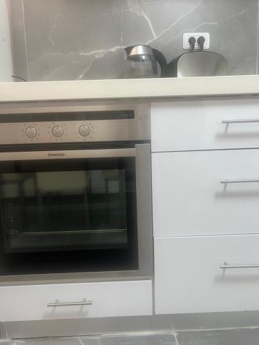 a kitchen with a stove and a sink at Buchman Cozy 1Bedroom Haven in Modi'in