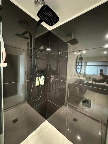 a bathroom with a shower and a sink at A Dreamed Home Away From Home in Rotorua