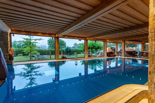 an indoor swimming pool with a large ceiling and windows at Hotel Freund - Privathotels Dr Lohbeck in Oberorke