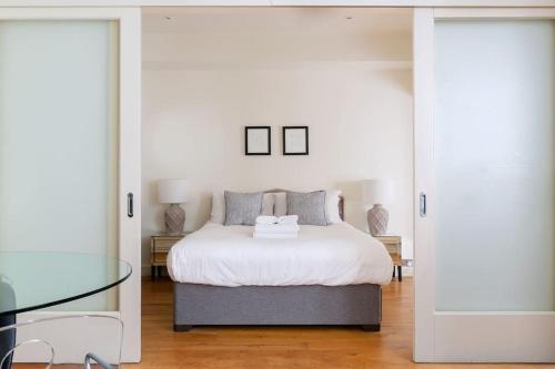 a bedroom with a bed and a glass table at Hyde Park - Knightsbridge - Private Entrance in London