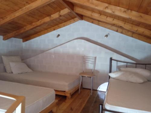 a room with two beds and a chair at SUNSHINE in Bríkion