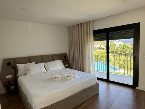 a bedroom with a bed with two white towels on it at Ermal Terrace in Vieira do Minho