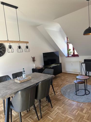 a living room with a dining room table and chairs at TraumFerienwohnung "Am Markt" in Pirna - Sächsische Schweiz in Pirna