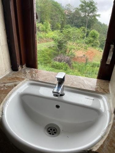 a white sink in front of a window at KAT RESORT PVT.LTD in Kakani