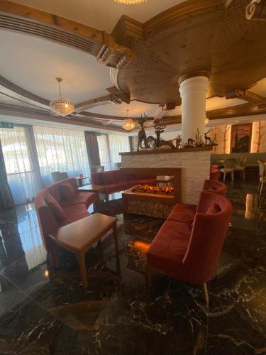 a living room with chairs and a fire place at Family Hotel La Perla in Fiera di Primiero