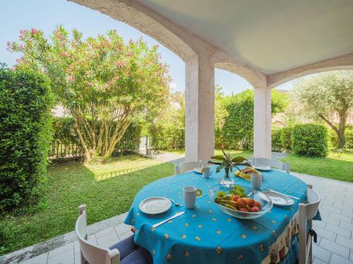 a blue table with a bowl of fruit on a patio at Holiday Home Lucerna Due-1 by Interhome in Ameglia