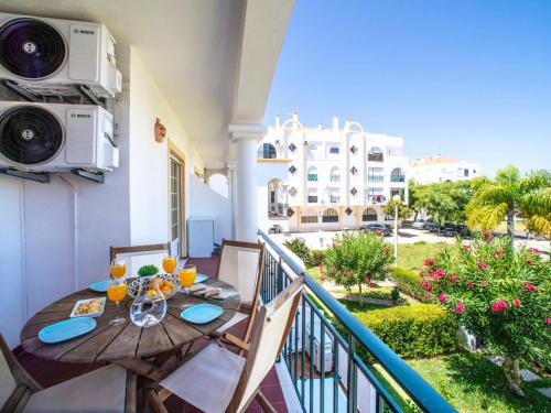 Un balcón con una mesa y sillas de madera y un balcón. en Apartment Rota do Sol by Interhome, en Altura