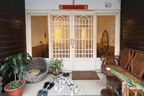 a group of shoes sitting in front of a door at Back to spring BnB in Hengchun