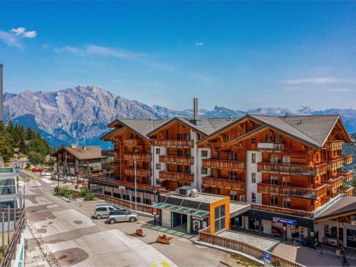 an aerial view of a lodge with mountains in the background at Apartment T-Resort La Tzoumaz 3p6 vue vallée by Interhome in La Tzoumaz