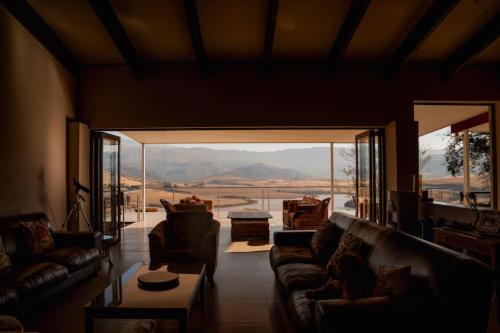 a living room with couches and a view of the desert at Valhalla, Cathkin Park in Bergview