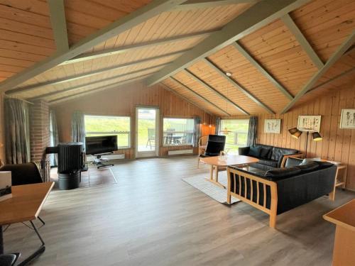 een woonkamer met een bank en een tafel bij Holiday Home Juha - from the sea in Western Jutland by Interhome in Bjerregård