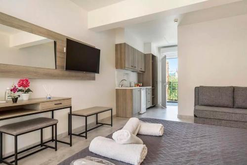 a living room with a table and a kitchen at Papatsas Center Houses in Nydri