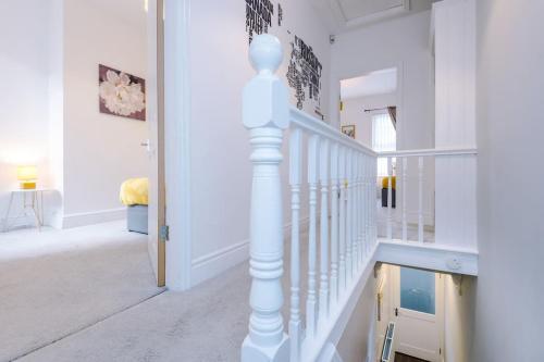 a white staircase in a home with white walls at Finchley House by Anfield in Liverpool