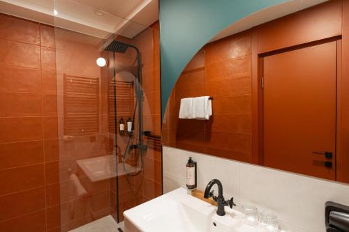 a bathroom with a sink and a shower at About Sololaki in Tbilisi City