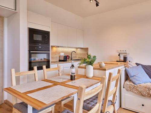 a kitchen and dining room with a wooden table and chairs at Studio Černý Důl-1 by Interhome in Cerny Dul