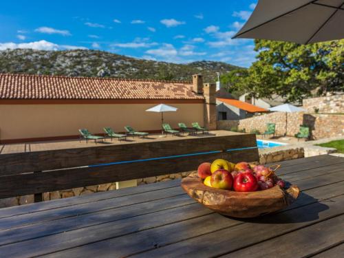 a bowl of fruit sitting on a wooden table at Holiday Home Lukata by Interhome in Drivenik