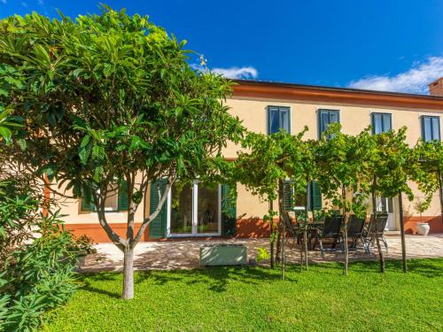 an exterior view of a house with trees in the yard at Holiday Home Lukata by Interhome in Drivenik