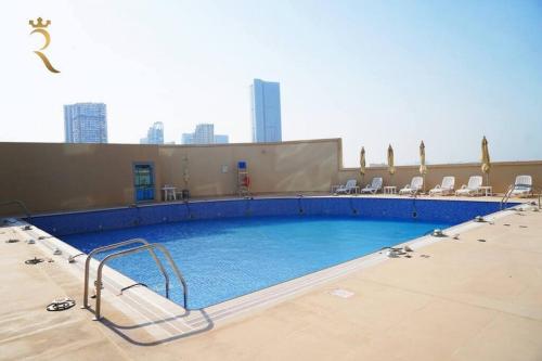 a large swimming pool on top of a building at Studio Escape in Al Reem Oasis Euphoria in Abu Dhabi