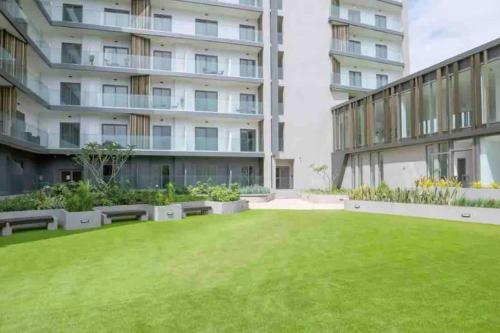 a large lawn in front of a building at Studio unit @ Airport The Lennox in Accra