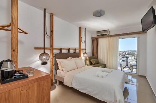 a hotel room with a bed and a balcony at Asana Hotel in Hersonissos