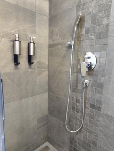 a bathroom with a shower with a glass door at Country Chic Pistoia-casa in campagna giardino, parking in Pistoia