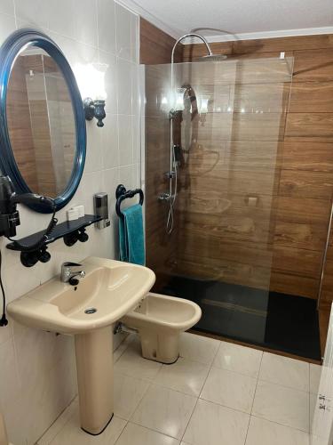 a bathroom with a sink and a shower with a mirror at Sole in Ajo