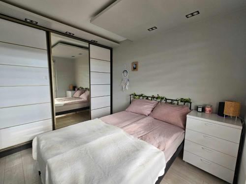 sypialnia z dużym łóżkiem i lustrem w obiekcie Apartament w centrum miasta z balkonem w Jastrzębiu Zdroju