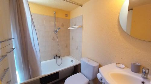 a bathroom with a white toilet and a sink at Panoramer in Théoule-sur-Mer