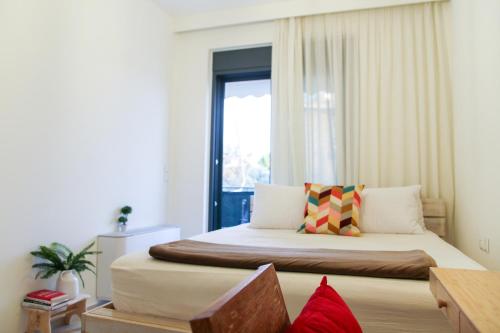 a bedroom with a large bed and a window at Phos Luxury Apartment in Lefkada