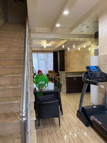an office with a gym with a table and a treadmill at GM Rest House in Tsaghkadzor