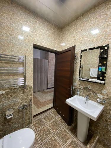 a bathroom with a sink and a shower and a toilet at GM Rest House in Tsaghkadzor