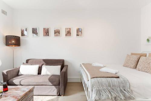 a living room with a bed and a couch at Cosy Inner-city Hideaway in the Heart of Annandale in Sydney